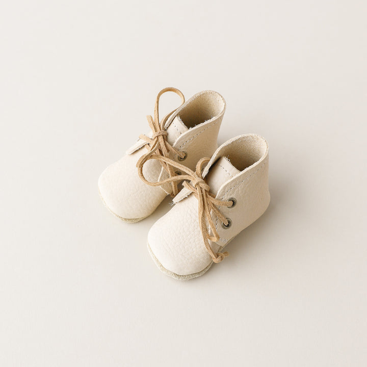 cream leather baby boots with soft soles. Suede laces.