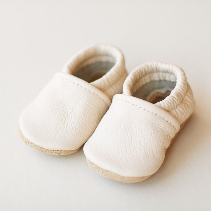 gender neutral cream leather baby shoes with elastic. slip-on style
