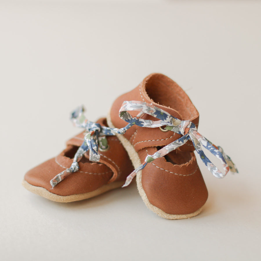 Baby Bella Janes in a medium brown leather. Product picture, one aged on top of the other. Soft soles.