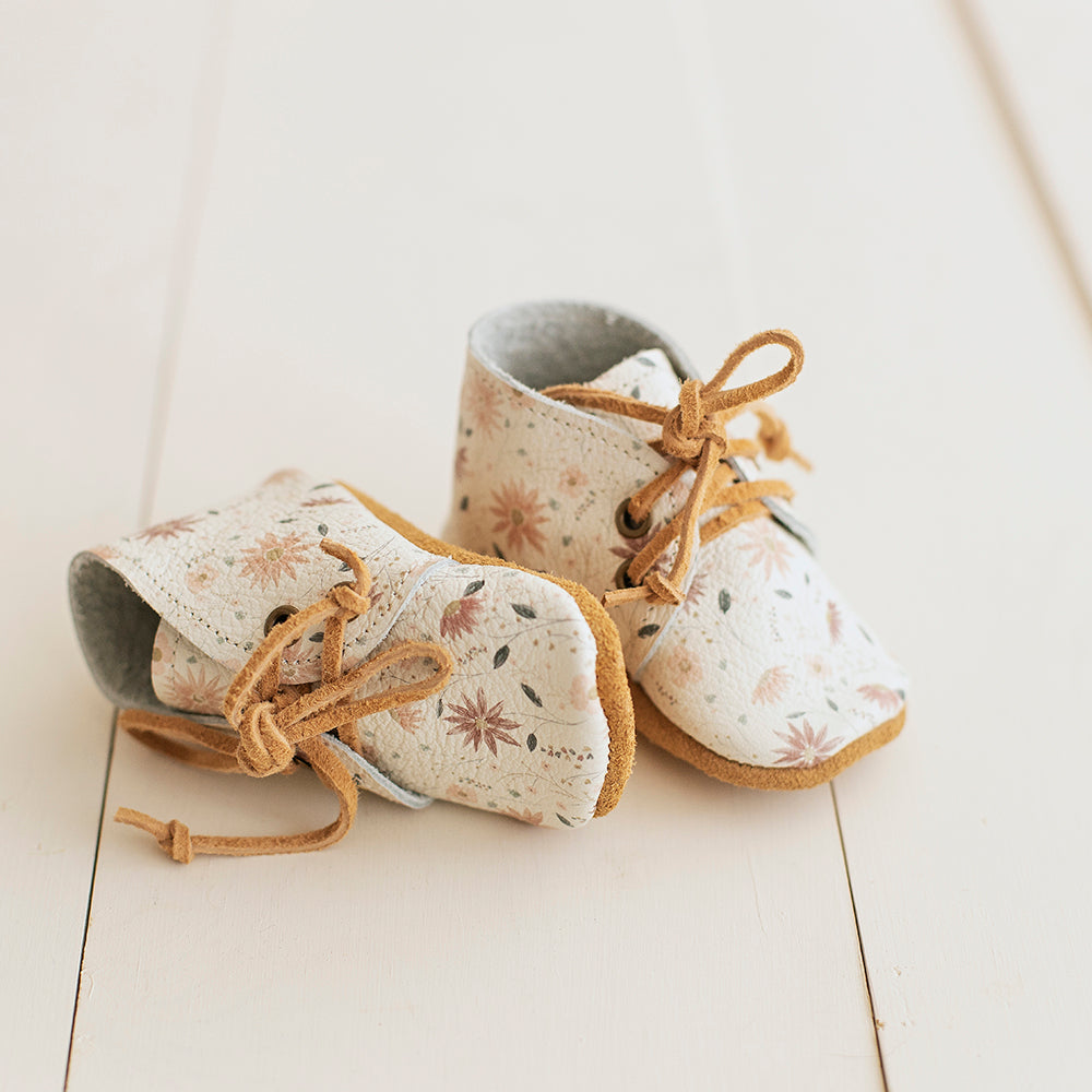 Soft sole baby girl boots with white and pink floral print.