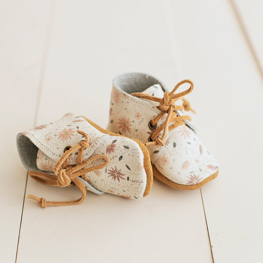 Soft sole baby girl boots with white and pink floral print.