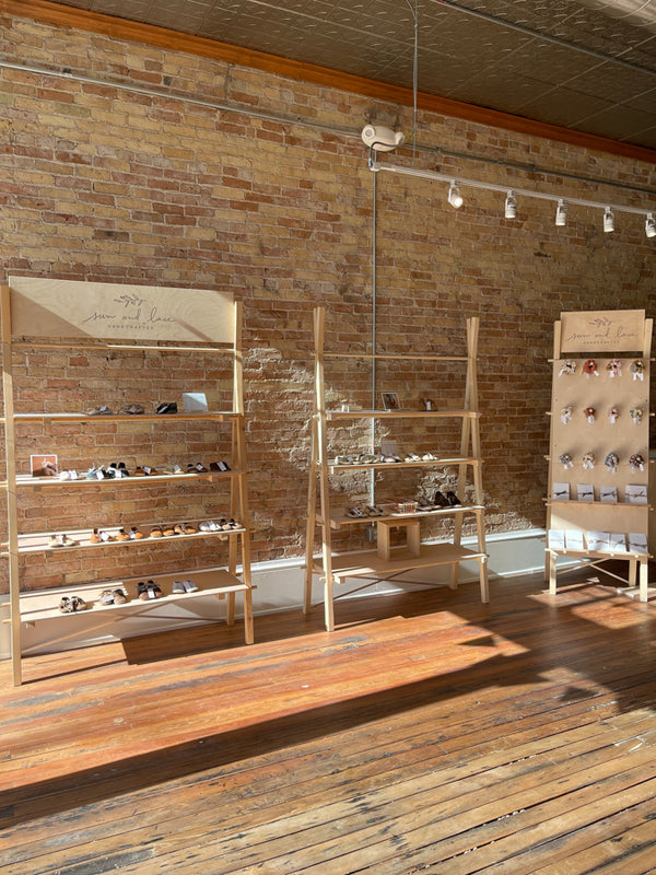 Sun & Lace shop in-person Stoughton WI. Exposed brick walls with original wood floors.