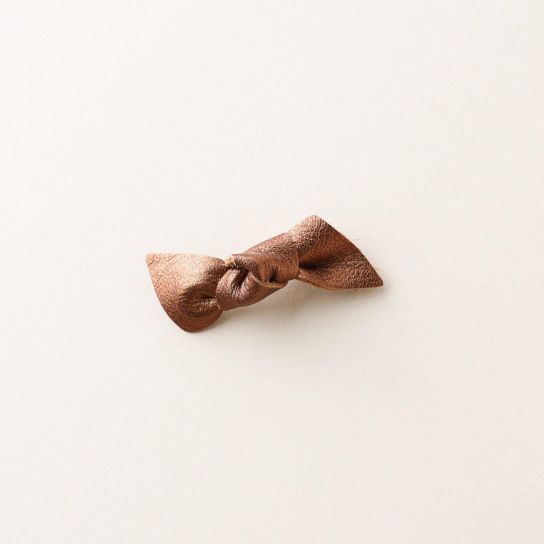Bronze bow barrette on a white background
