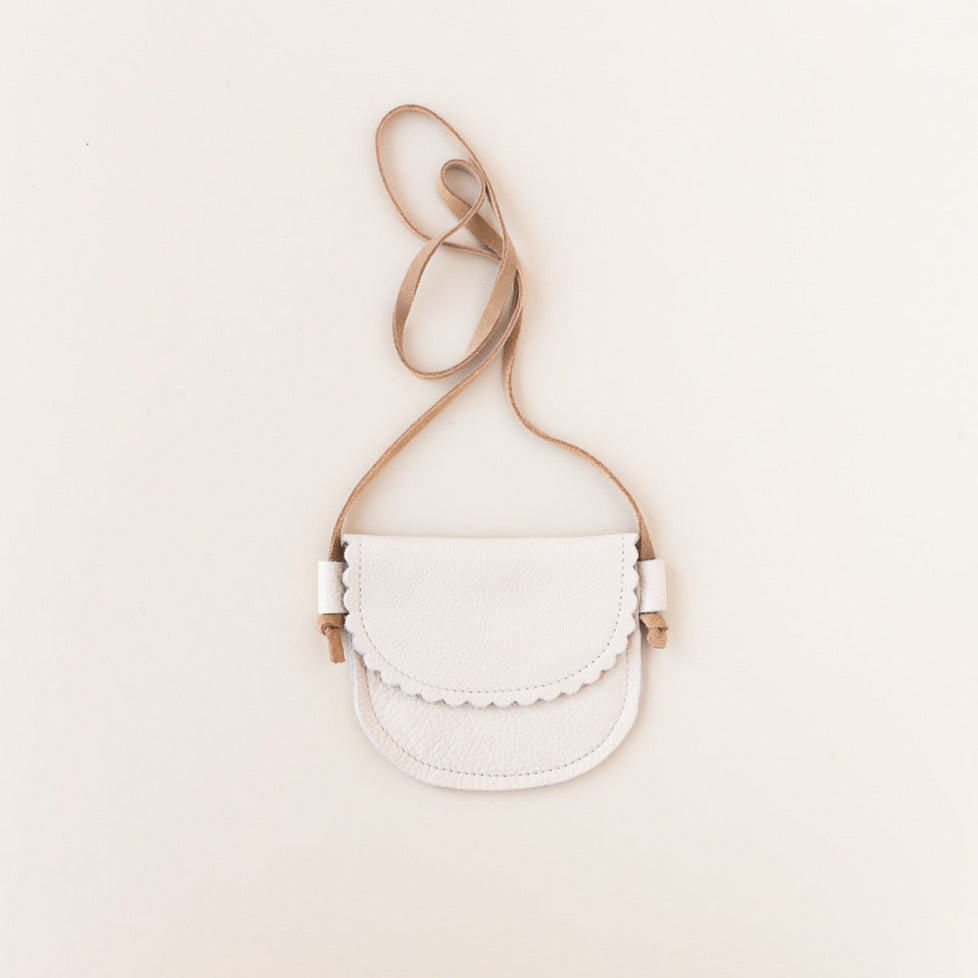 cream leather little girls purse on gray background