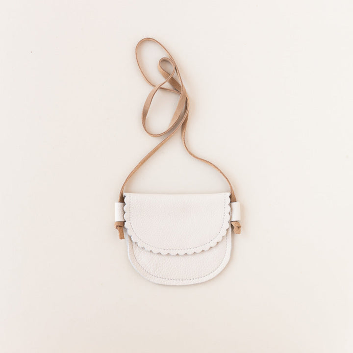 cream leather little girls purse on gray background