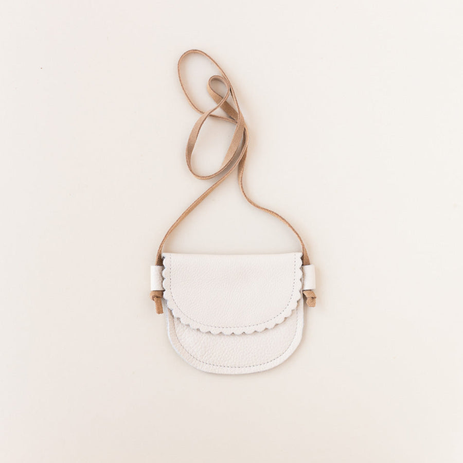 cream leather little girls purse on gray background