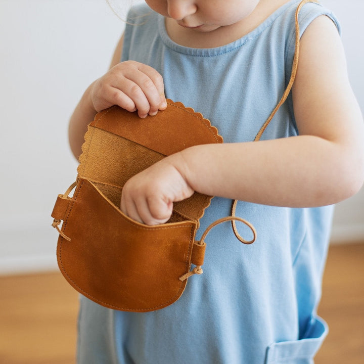 toddler girl using her leather purse