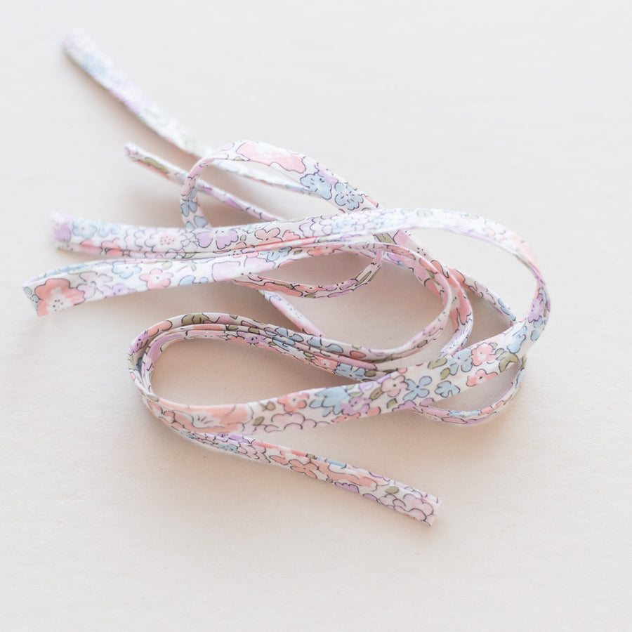 Floral-patterned shoelaces on a light background