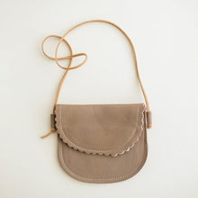 taupe leather toddler purse on cream background. scalloped edge.