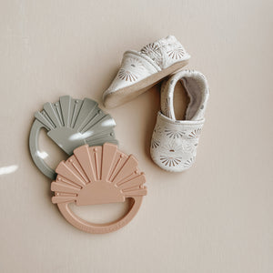 gender neutral slip-on baby shoes with sunshine print in clay, sage and beige. soft sole crib shoes with suede soles.