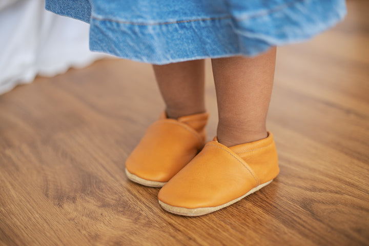 toddler standing wearing slip on shoes