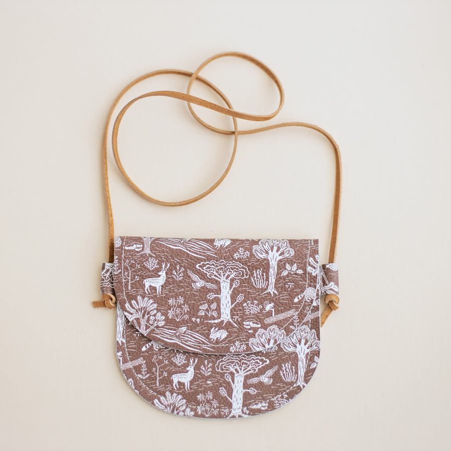 leather bag in Winter Water Factory's in the forest print. brown with white trees and animals