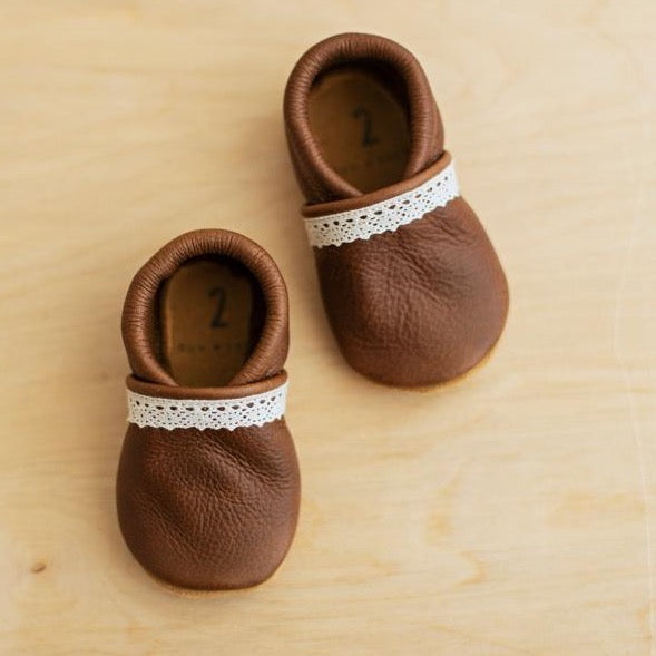 Brown leather baby girl shoes with soft soles. slip on leather baby moccs for first shoes and baby gifts.